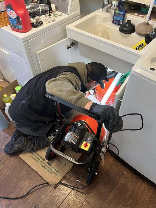 plumber providing drain cleaning services