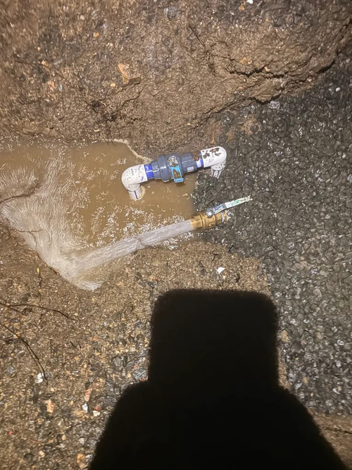 water flowing from an outdoors pipe