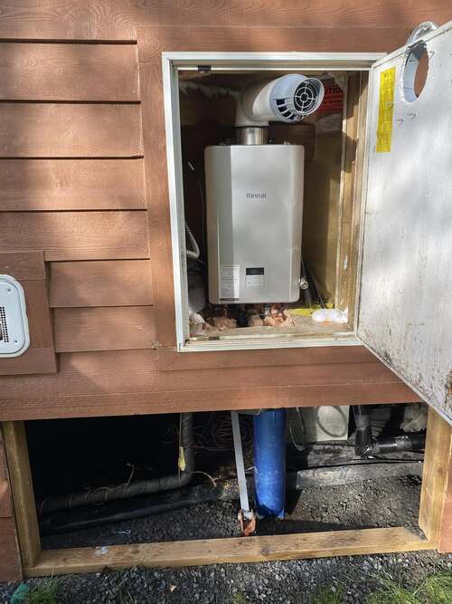 tankless water heater in the wall of a home